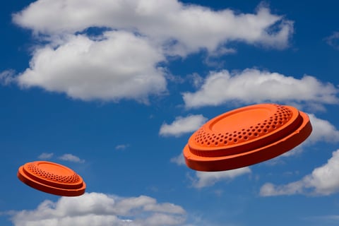 Flying clay pigeon target in the blue sky