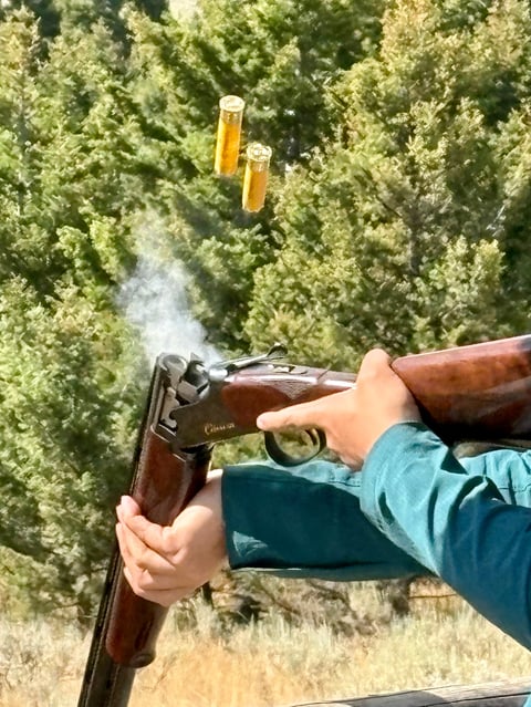 Shooter ejects shotgun shells showing freeze motion